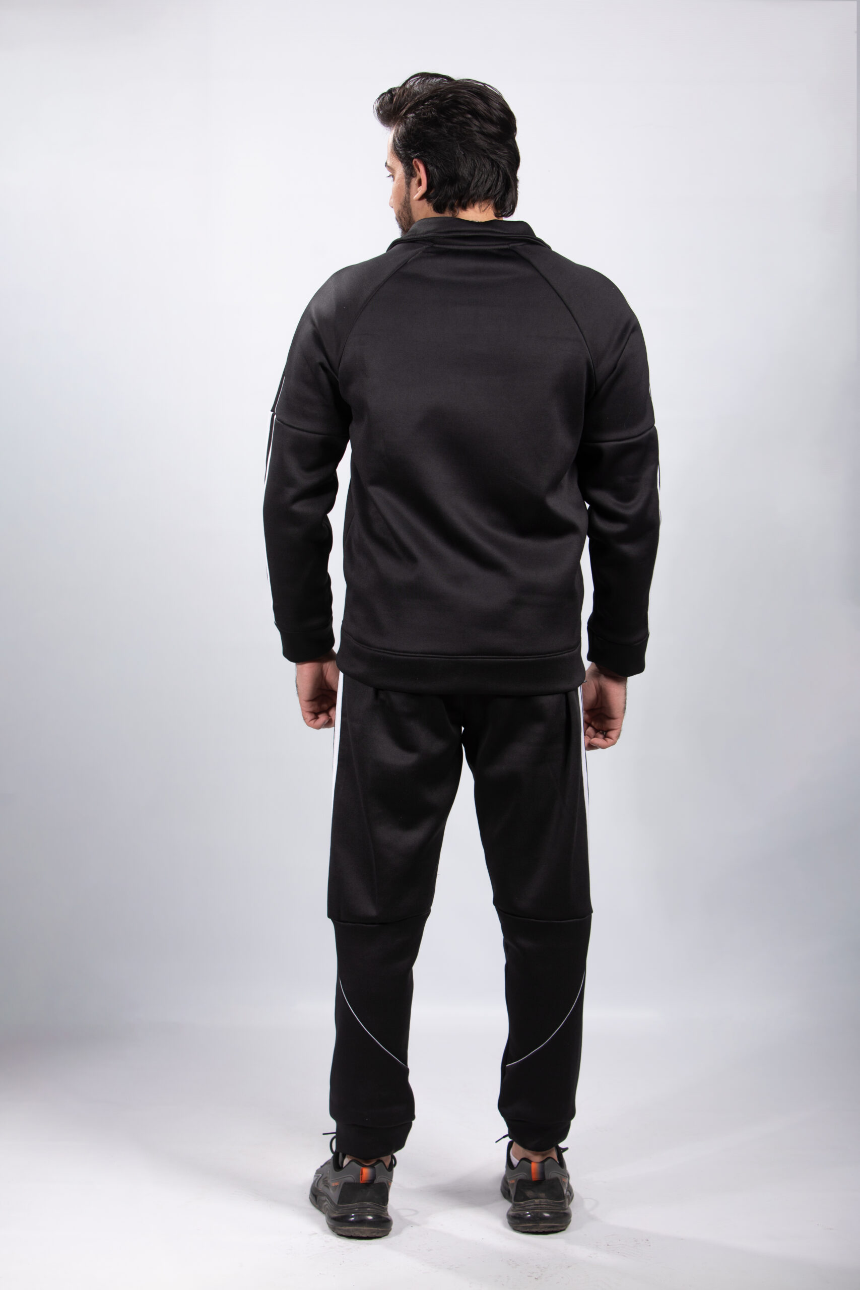 model wearing black tracksuit back